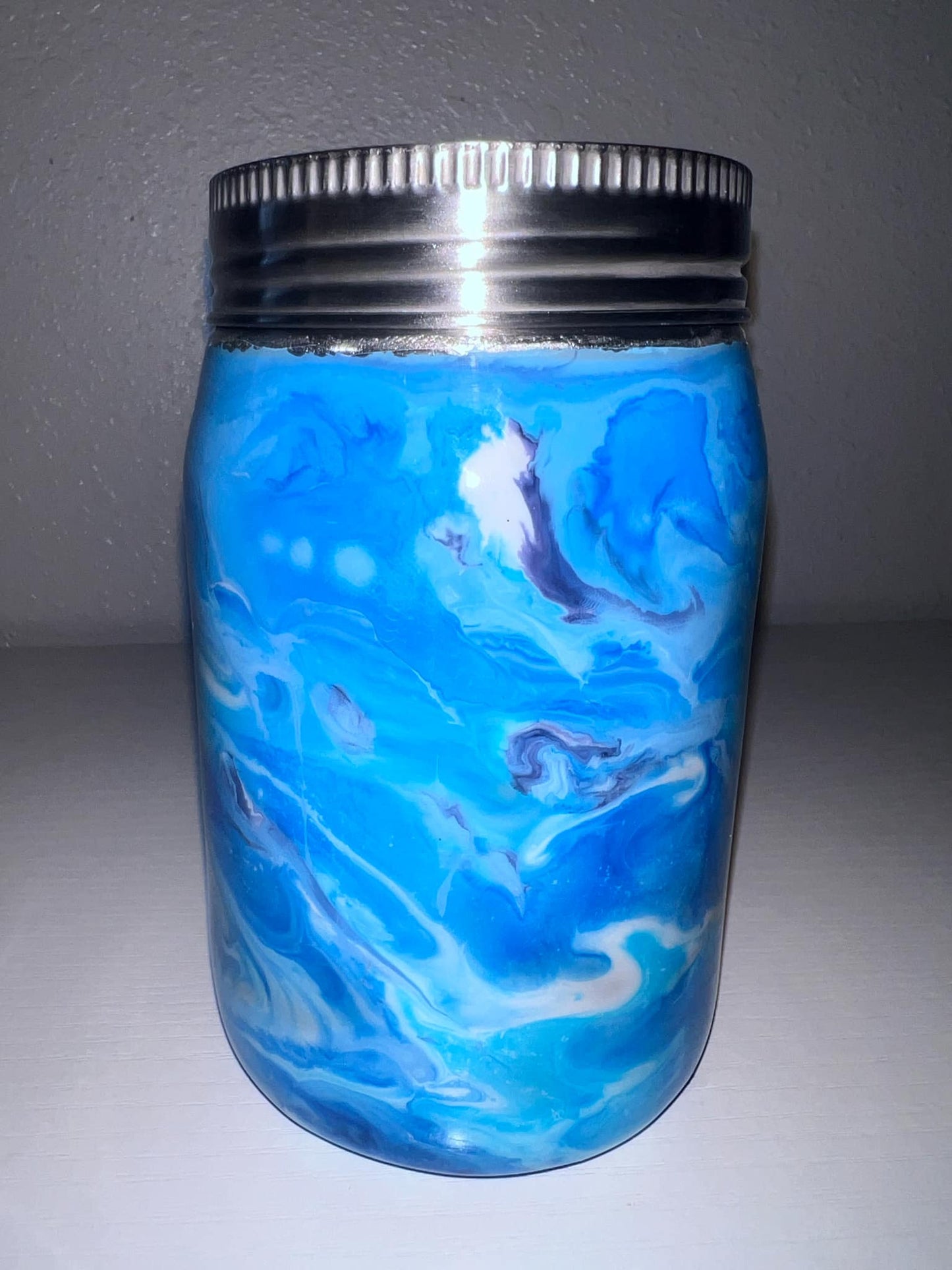 #45 12oz Blue and white swirls Mason Jar with a blue glow