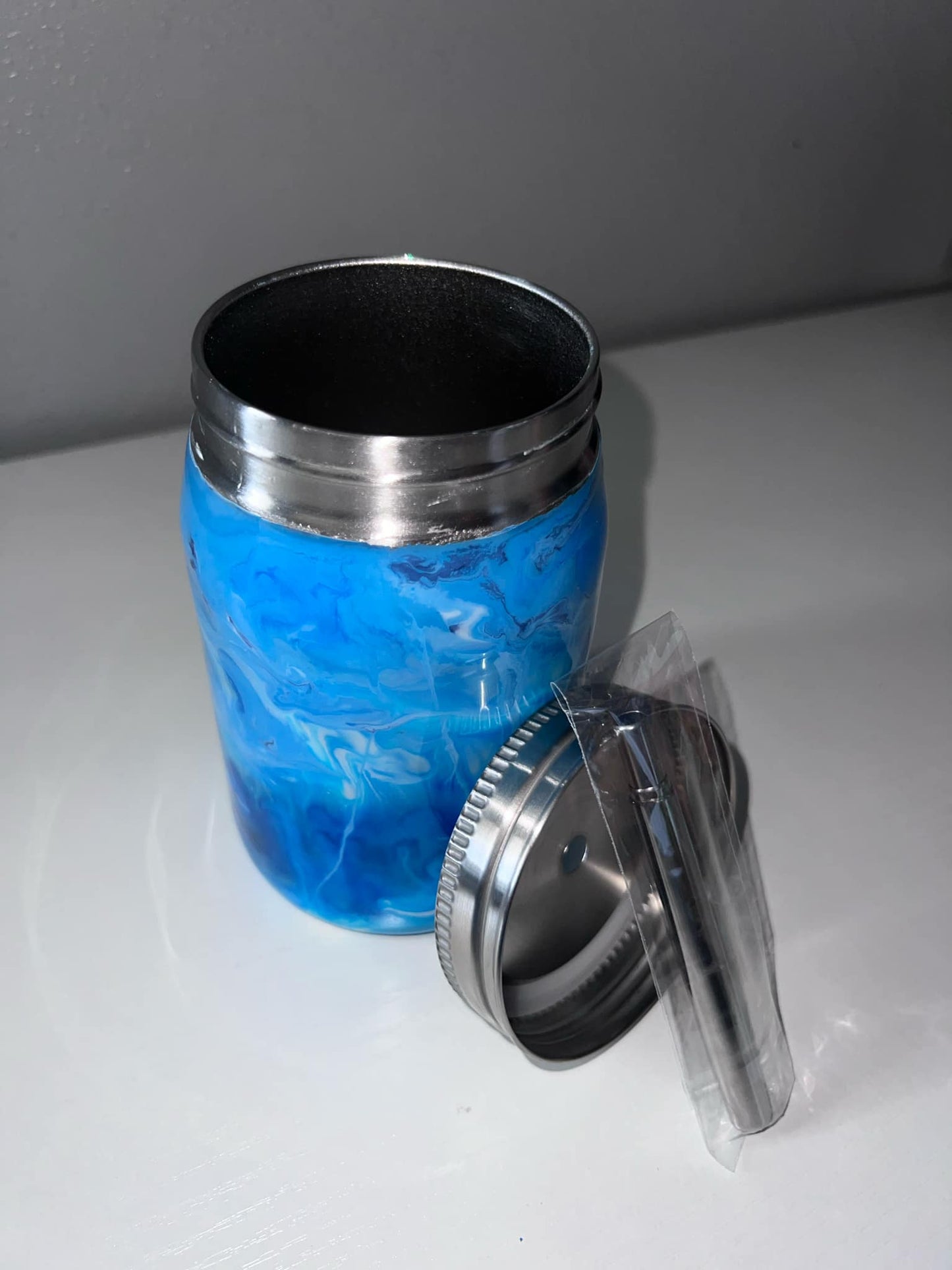 #45 12oz Blue and white swirls Mason Jar with a blue glow